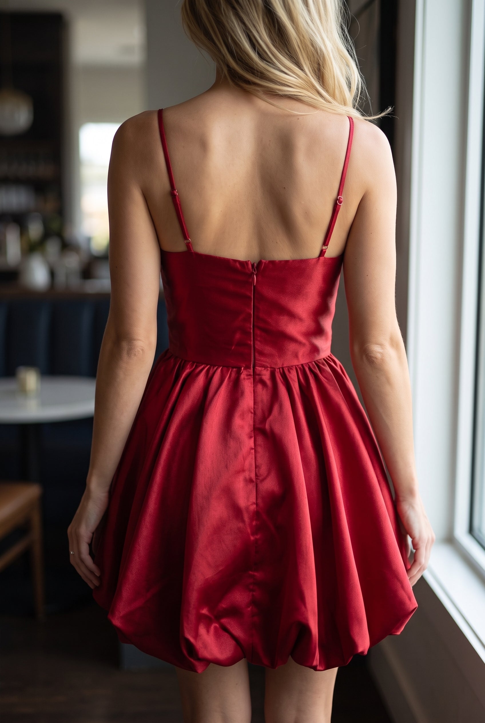 Back fit of the red scallop bubble mini dress showing the low back, adjustable straps and center zipper.