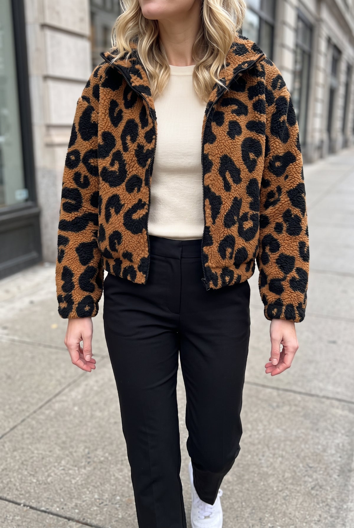 Going Wild leopard jacket in Small styled open over a fitted knit on a cool city street.