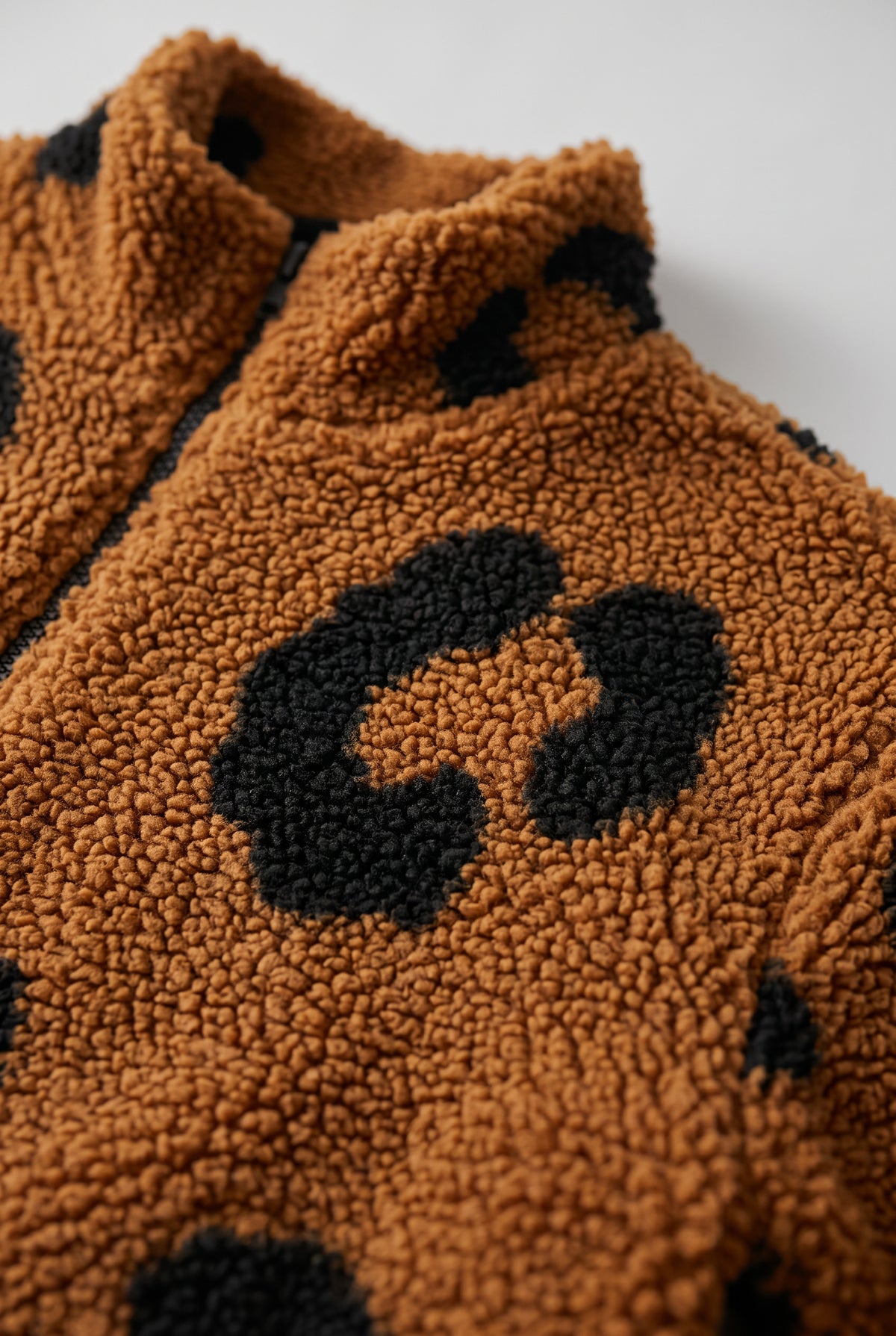 Close-up of the Going Wild leopard jacket showing the faux sherpa pile and matte finish.