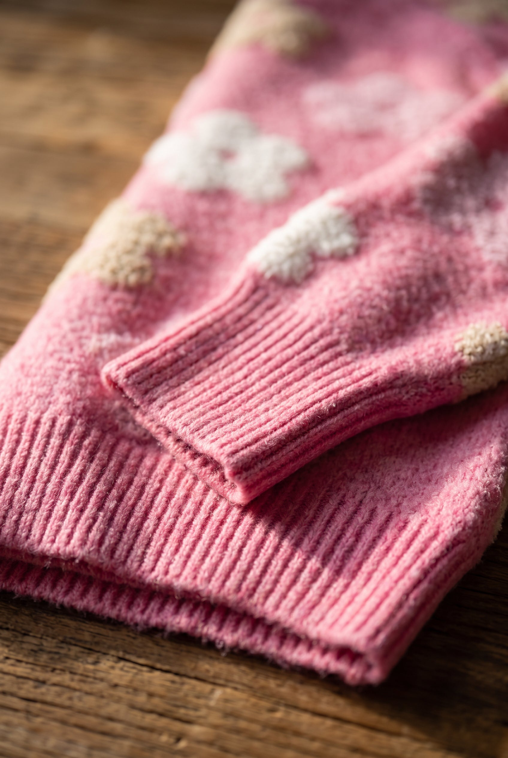 Close-up of the Everly Floral Sweater Top showing its ribbed cuff, hem and fuzzy knit finish.