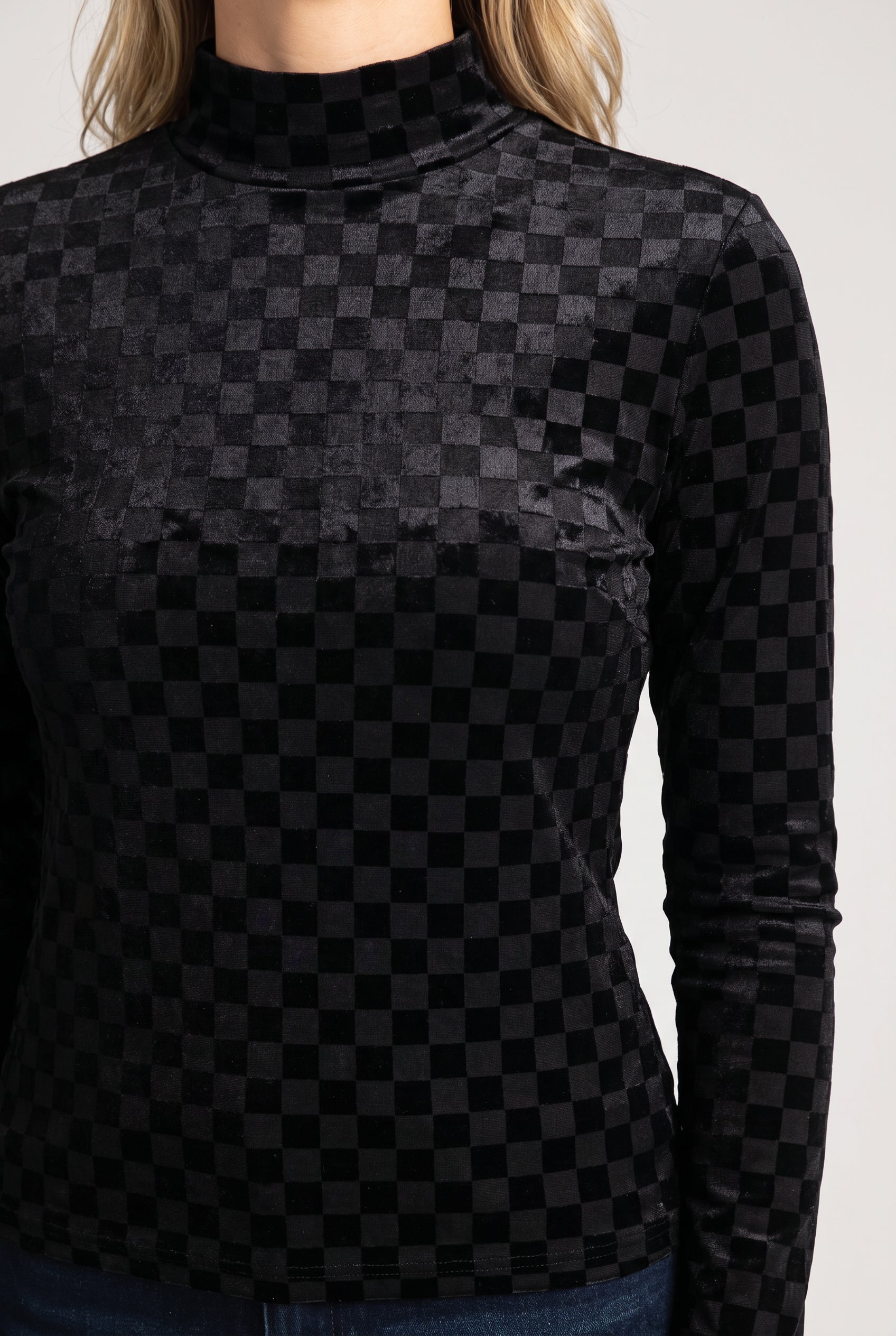 Close view of the Everybody Needs Someone top showing the velvet checker surface and shoulder stitching.