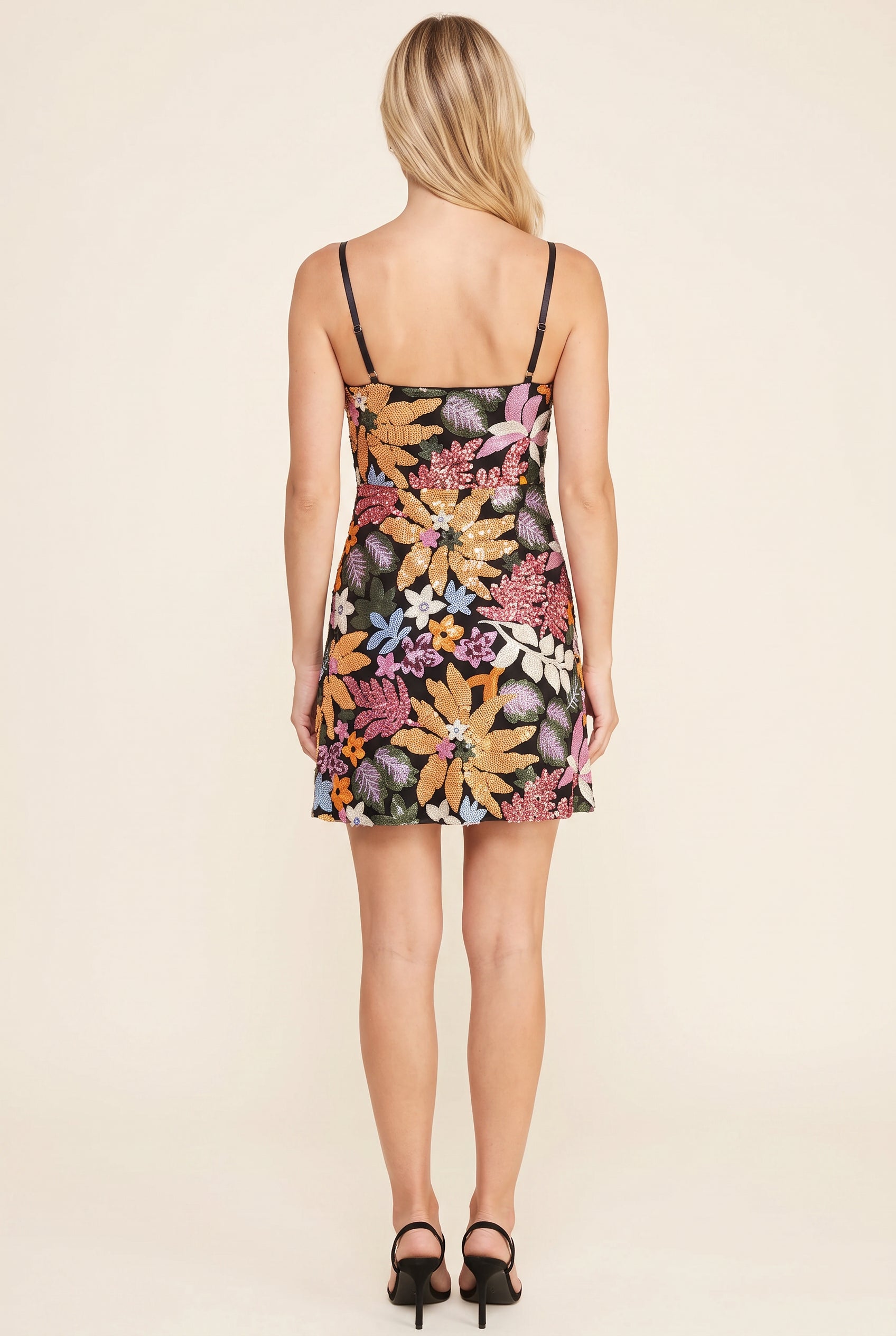 Back fit of the Floral Radiance sequin mini dress showing its low back, straps and short A-line hem.