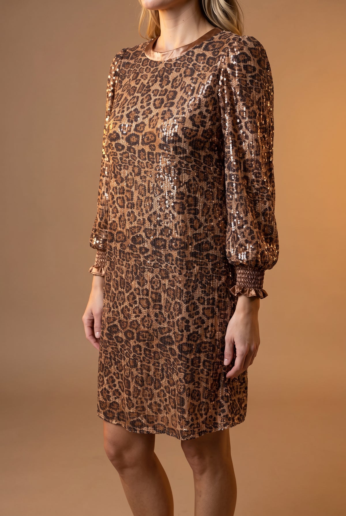 Side view of the Going Wild leopard sequin dress showing bust ease, shift depth, and mini hem.