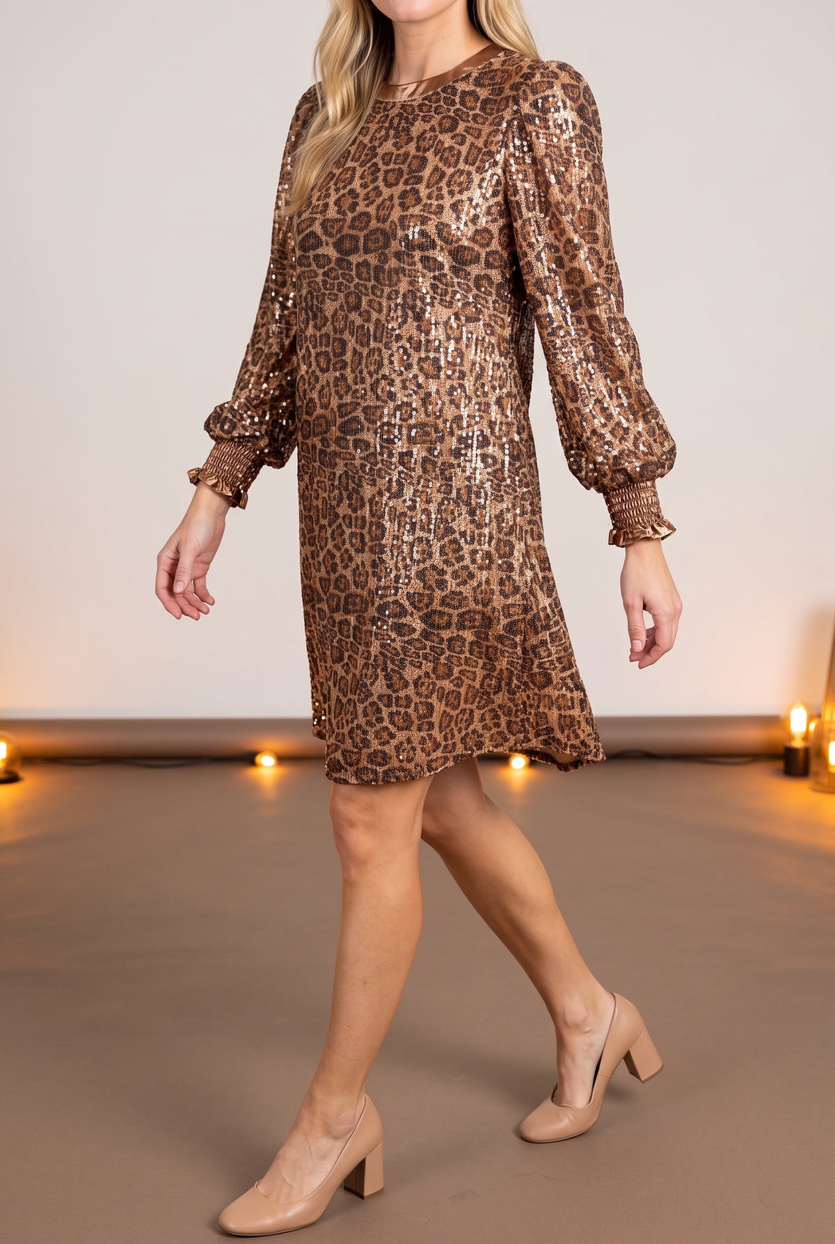 Going Wild leopard sequin mini dress styled for a party, showing sleeve volume and hem movement.