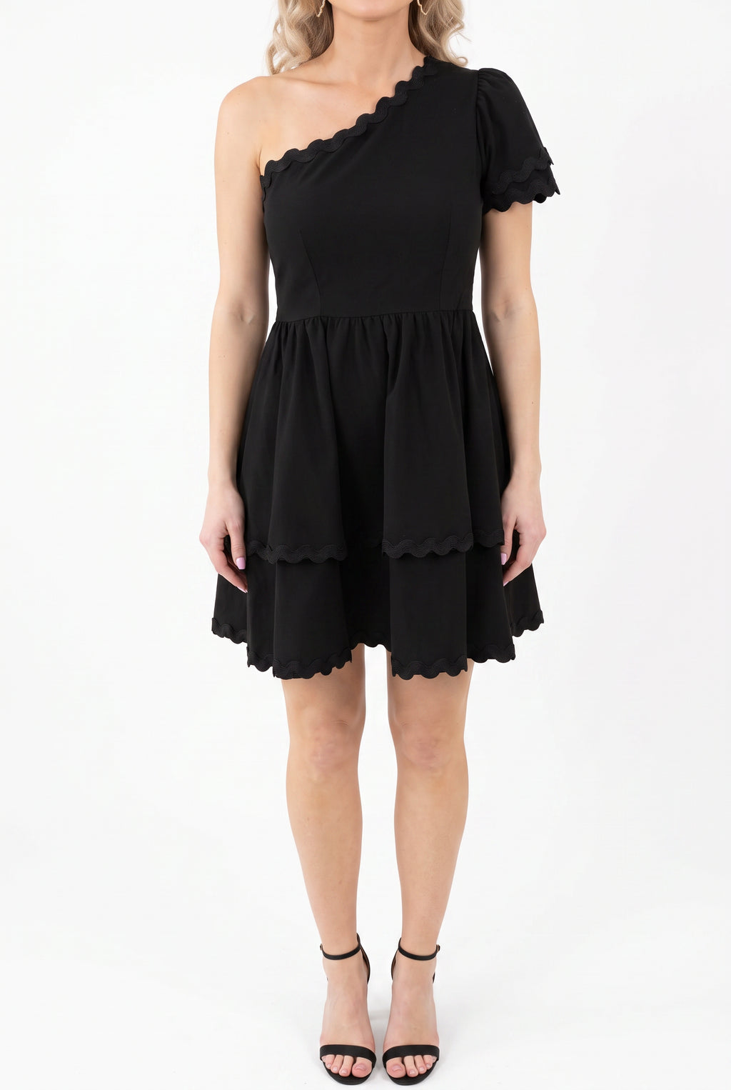 Flirty Noir Fantasy black mini dress shown straight-on with its one-shoulder neckline and tiered skirt.