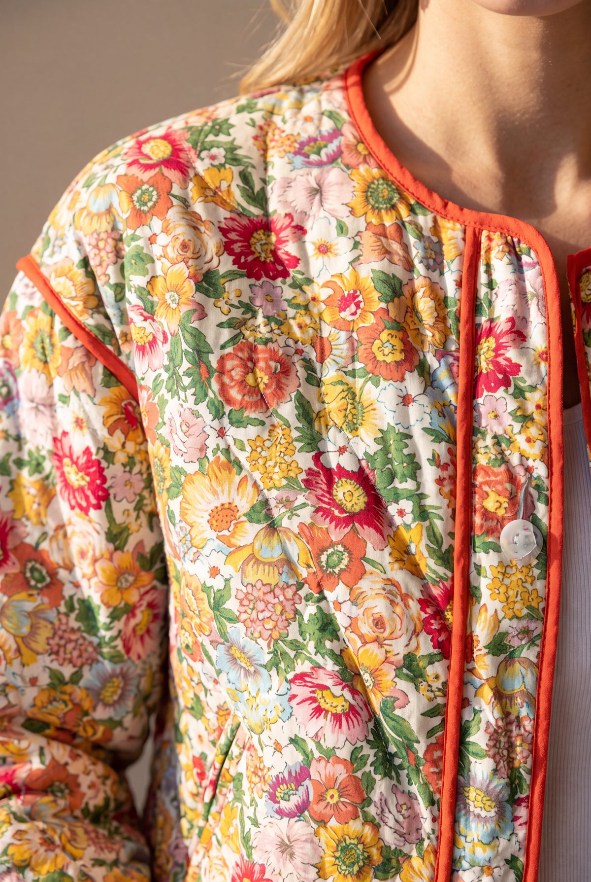 Floral cotton, quilting and orange trim detail on the Good Feeling Cotton Jacket.
