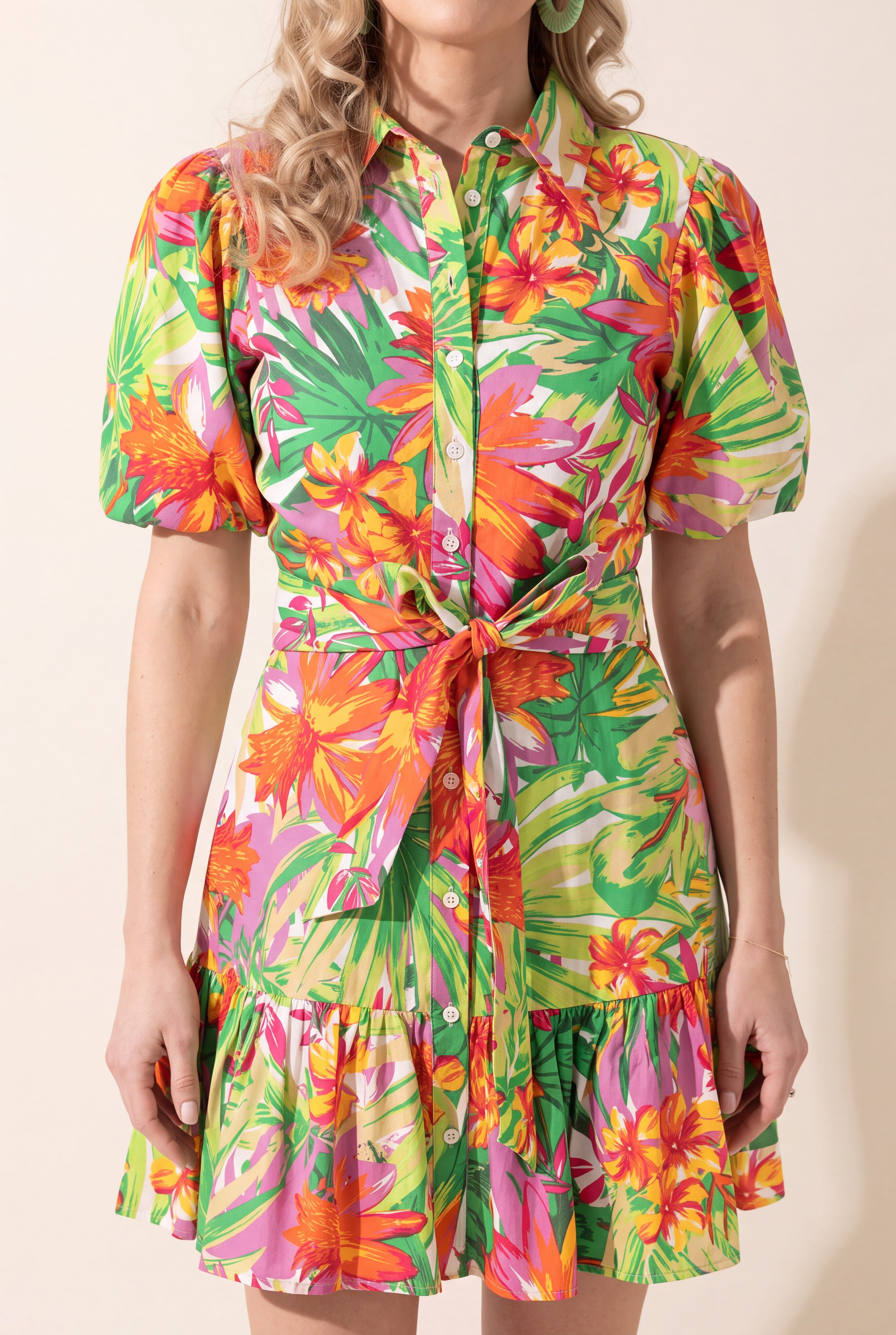 Close detail of the floral cotton poplin, buttons, puff sleeve and tie waist.