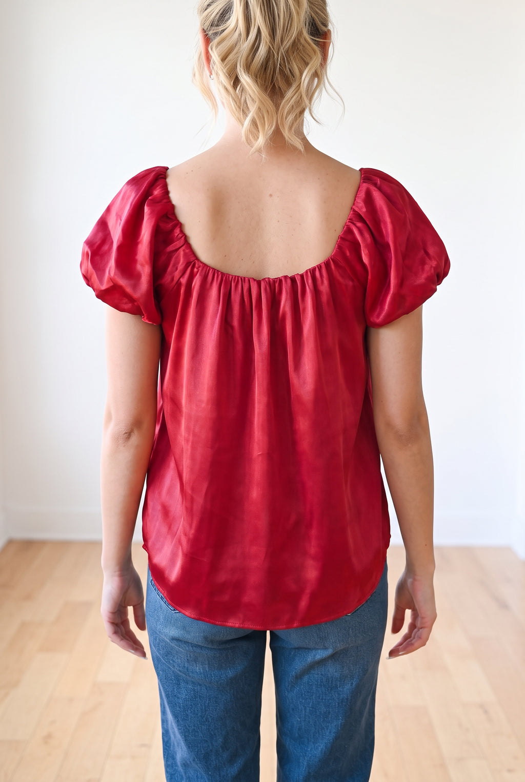 Back fit of the Red puff sleeve satin top in Small, showing the low square back and curved hem.