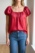 Red puff sleeve satin top in Small styled with denim and a front half-tuck.