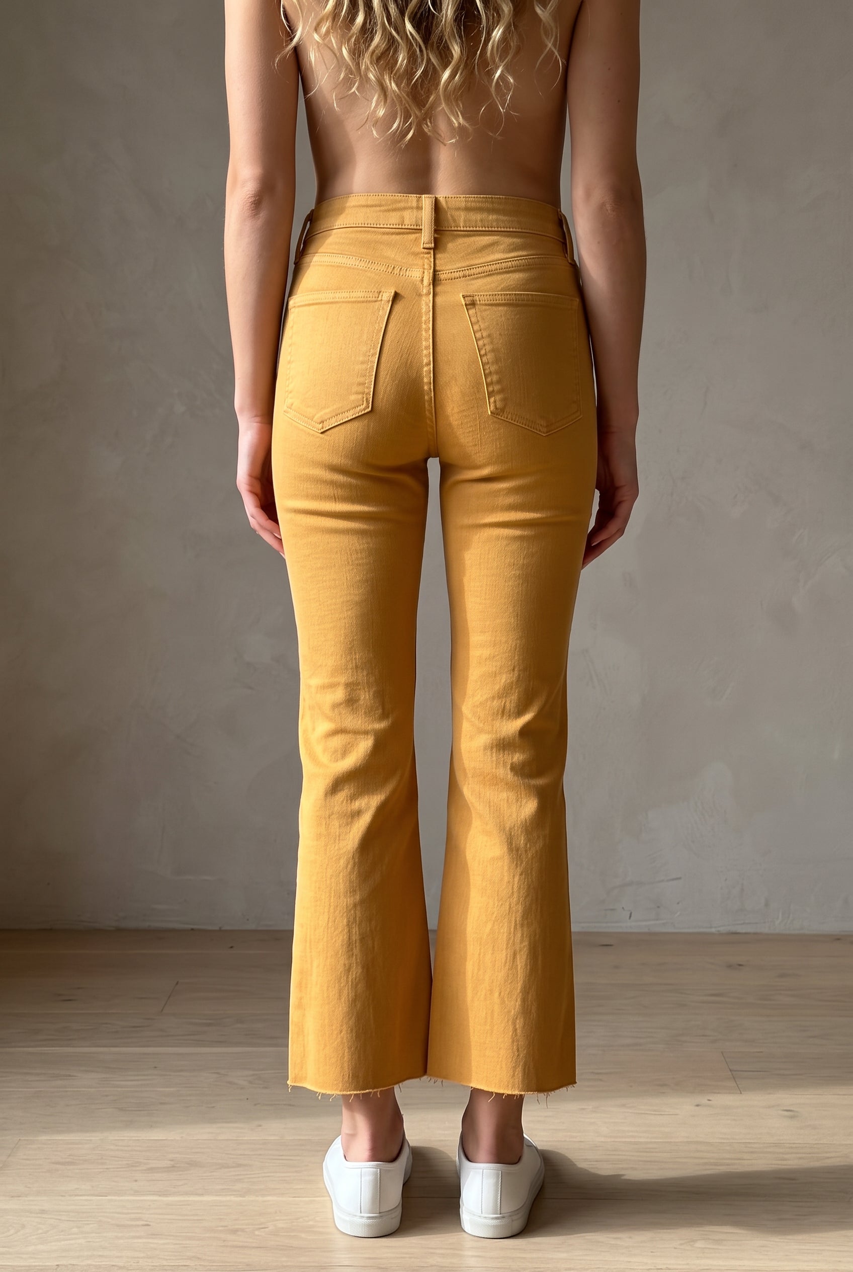 Back fit of Gold size 25 kick-flare pants showing the V-yoke, patch pockets and cropped hems.