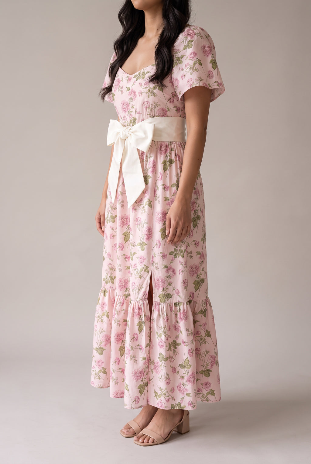 Angled side fit of the Small pink floral dress showing the flutter sleeve and ankle-length fall.