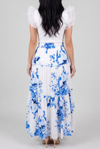 Back fit of the blue floral tiered maxi skirt showing the smocked waist and natural tiered drape.