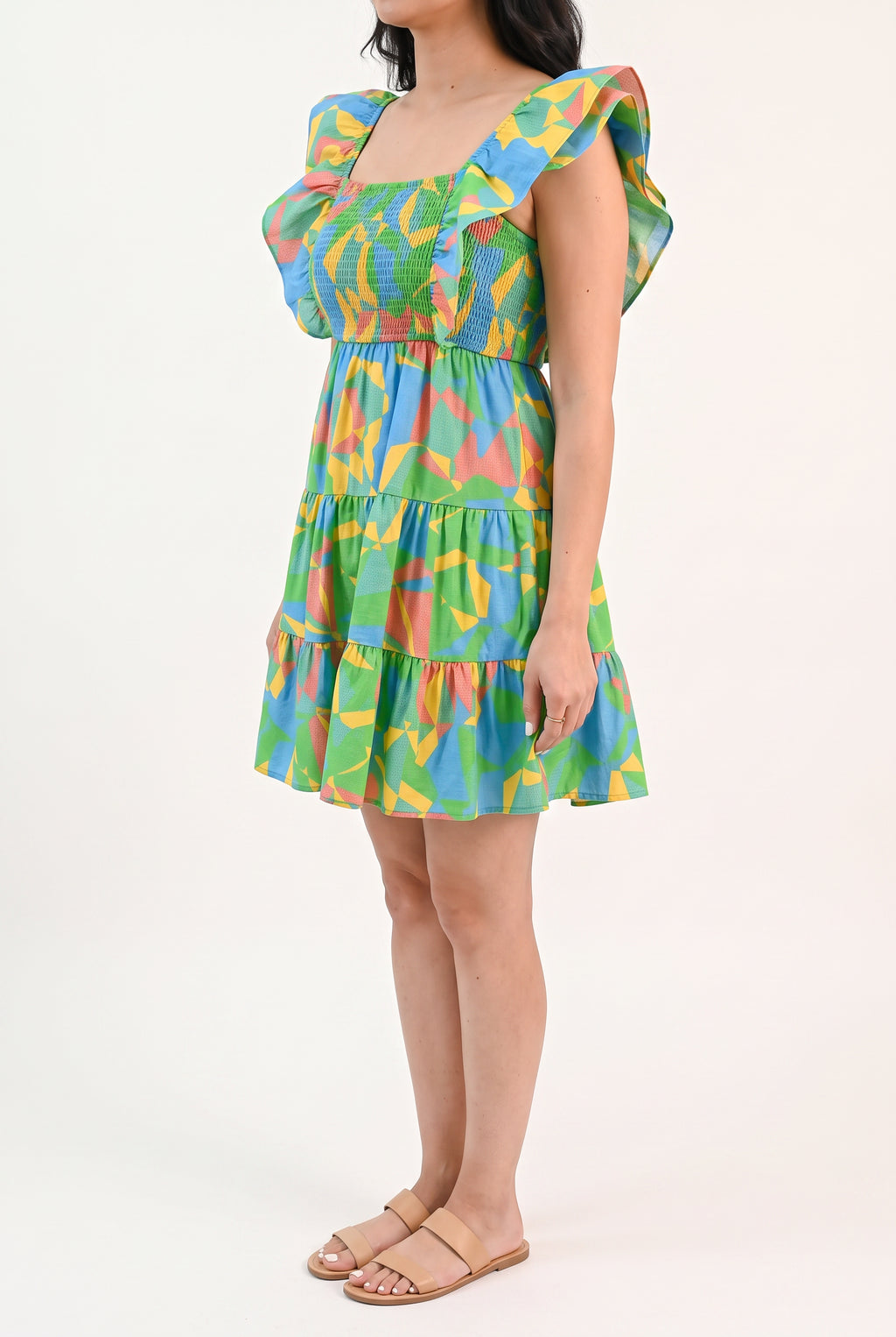 Angled side fit of the flutter sleeve mini dress showing armhole coverage and ruffle volume.