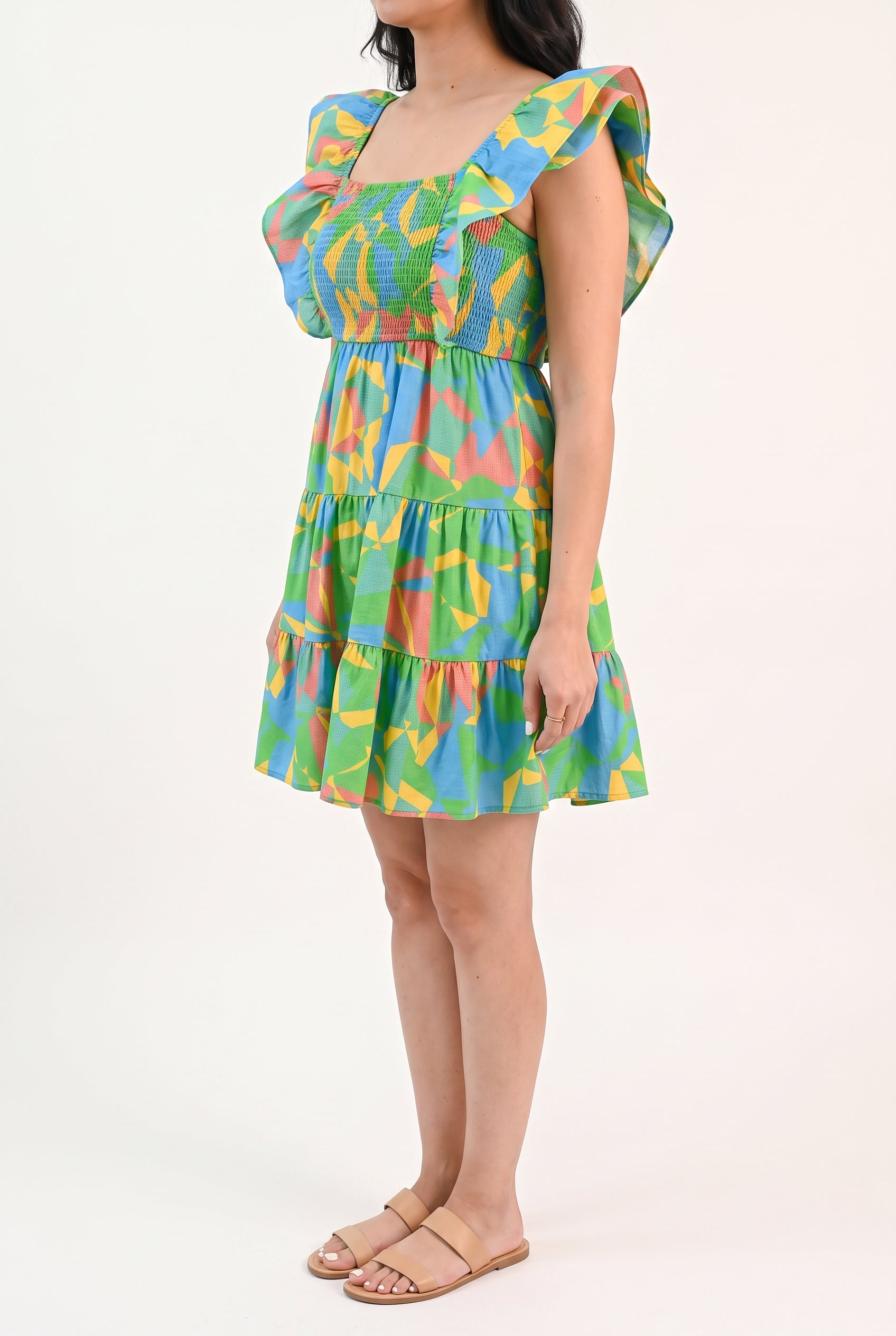 Angled side fit of the flutter sleeve mini dress showing armhole coverage and ruffle volume.