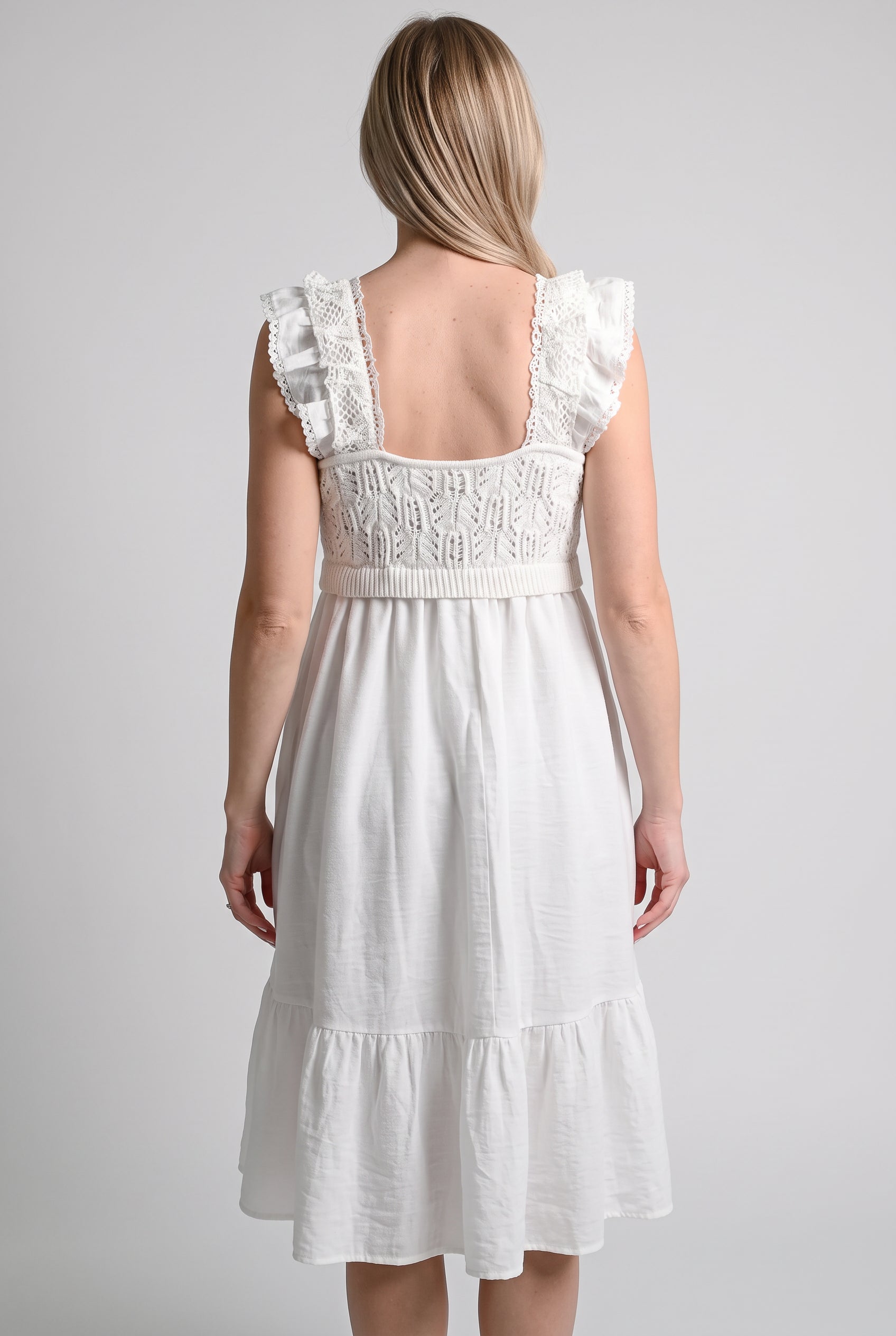 Back fit of the white crochet midi dress showing its low square back and tiered hem.