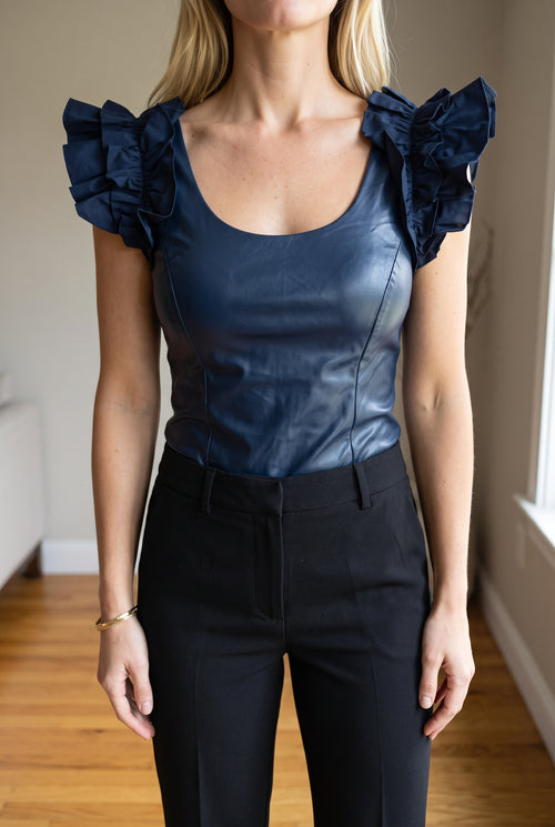 Front fit of the navy After Hours Bodysuit with ruffle shoulders and tailored trousers.