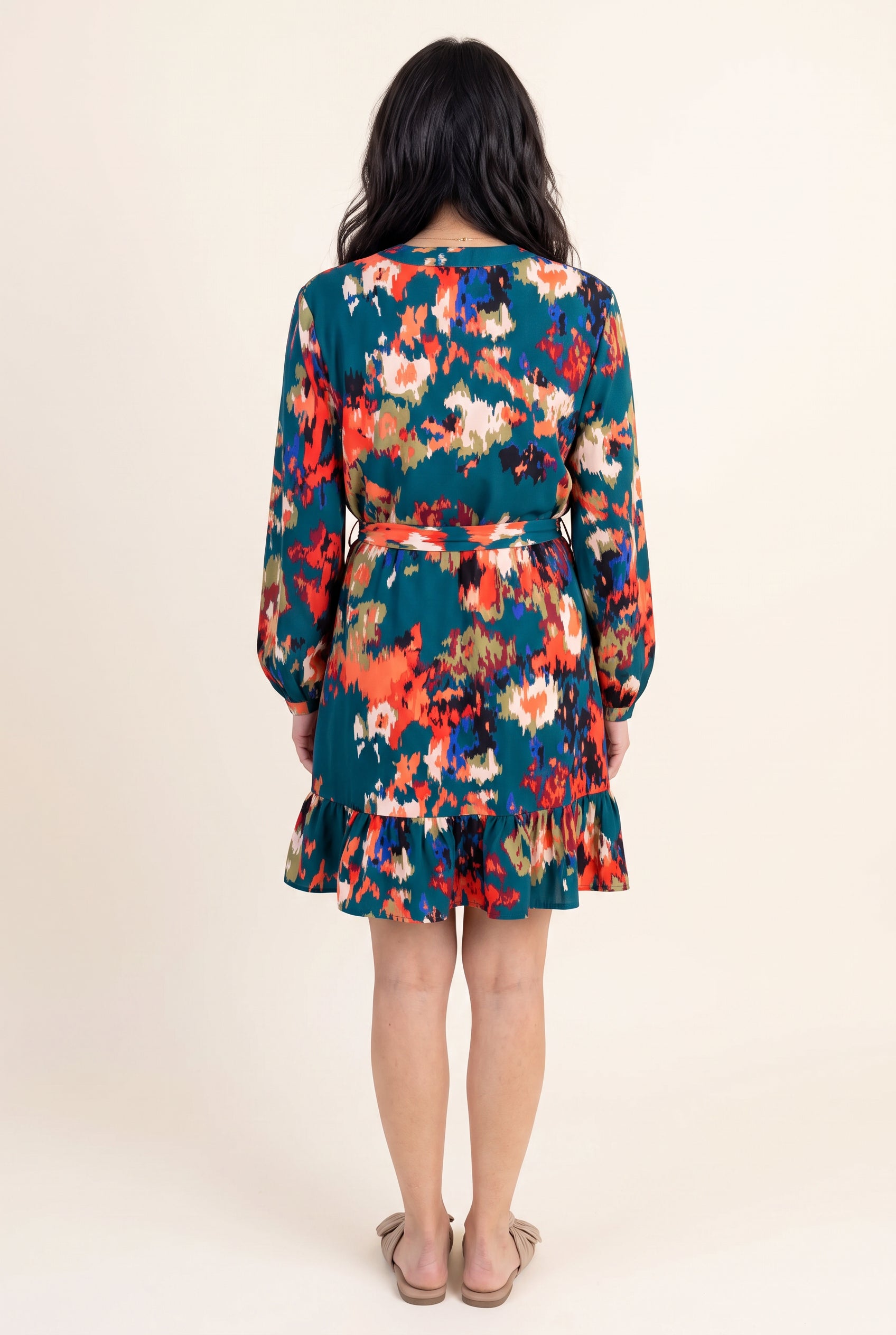 Back view of Shweta wearing the Small Teal ruffled high-waist mini dress.