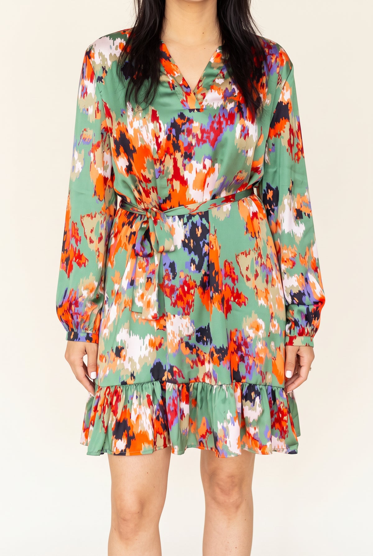 Shweta wearing the Small Green ruffled high-waist mini dress from the front.