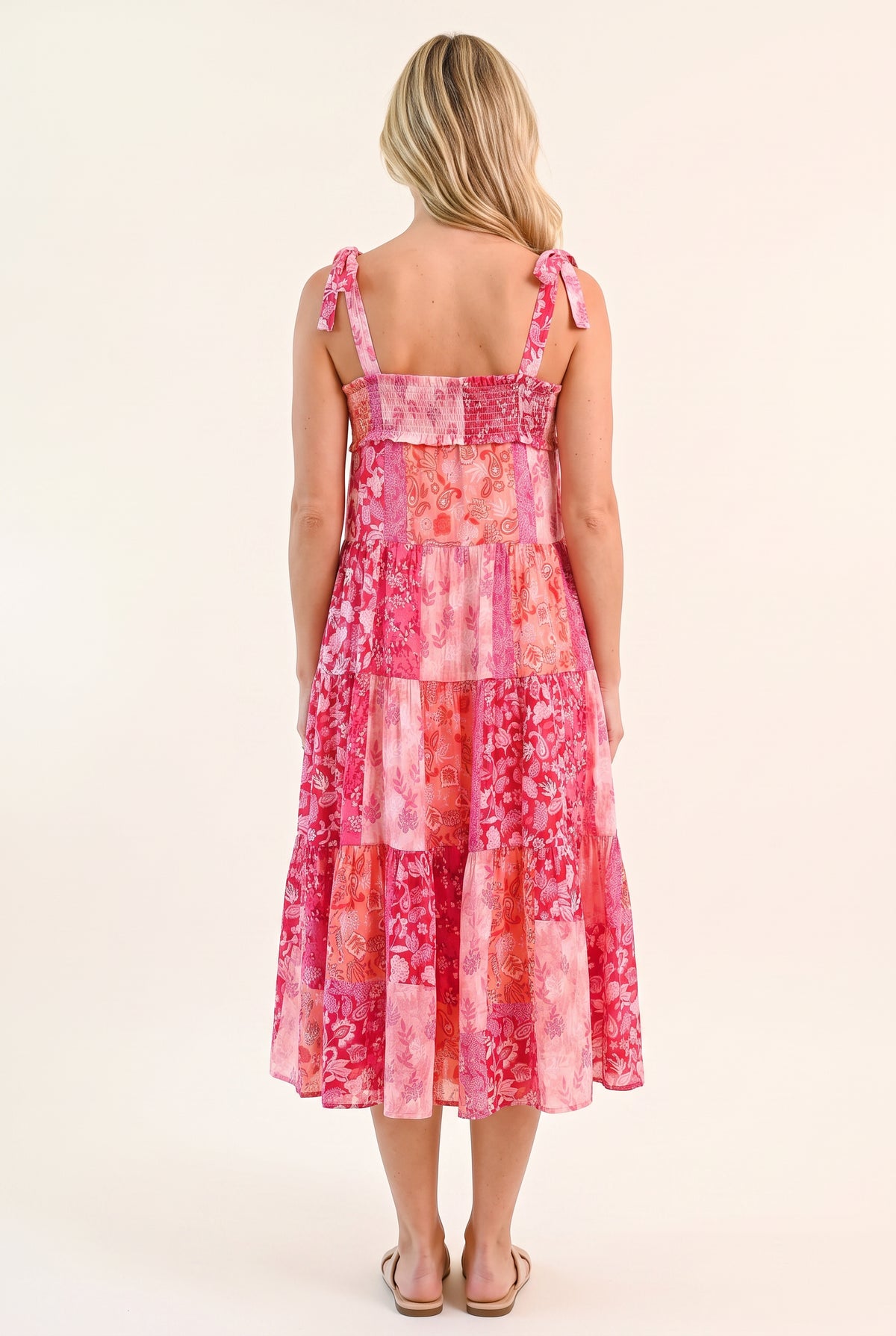 Straight back of the pink patchwork midi dress showing its square neckline and smocked band