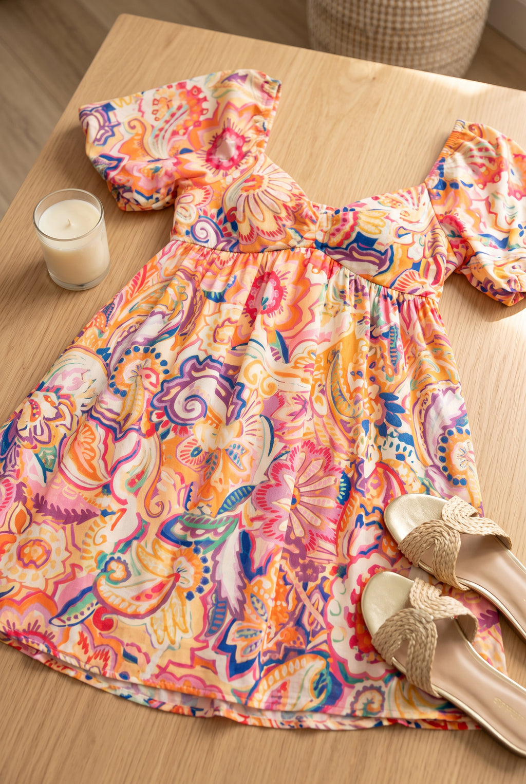 Close detail of the Create Your Sunshine Mini Dress fabric, floral print and turned hem stitching.