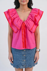 Front view of the pink ruffle babydoll top in Small showing its wide collar and loose A-line fit.