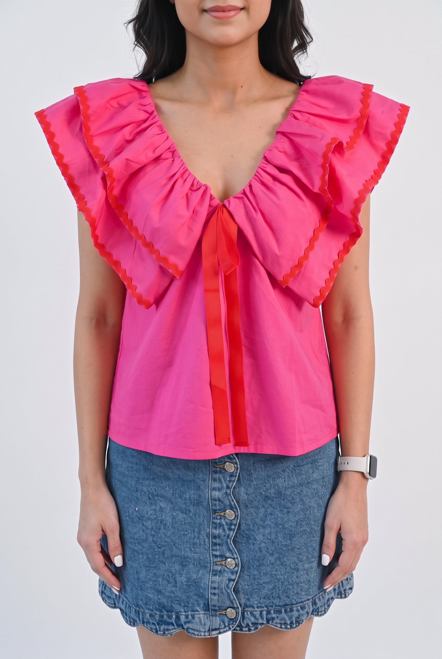 Front view of the pink ruffle babydoll top in Small showing its wide collar and loose A-line fit.