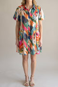Front fit of the Sunset Swing Tropical Shirt Dress in Small with its relaxed bodice and swing mini skirt.