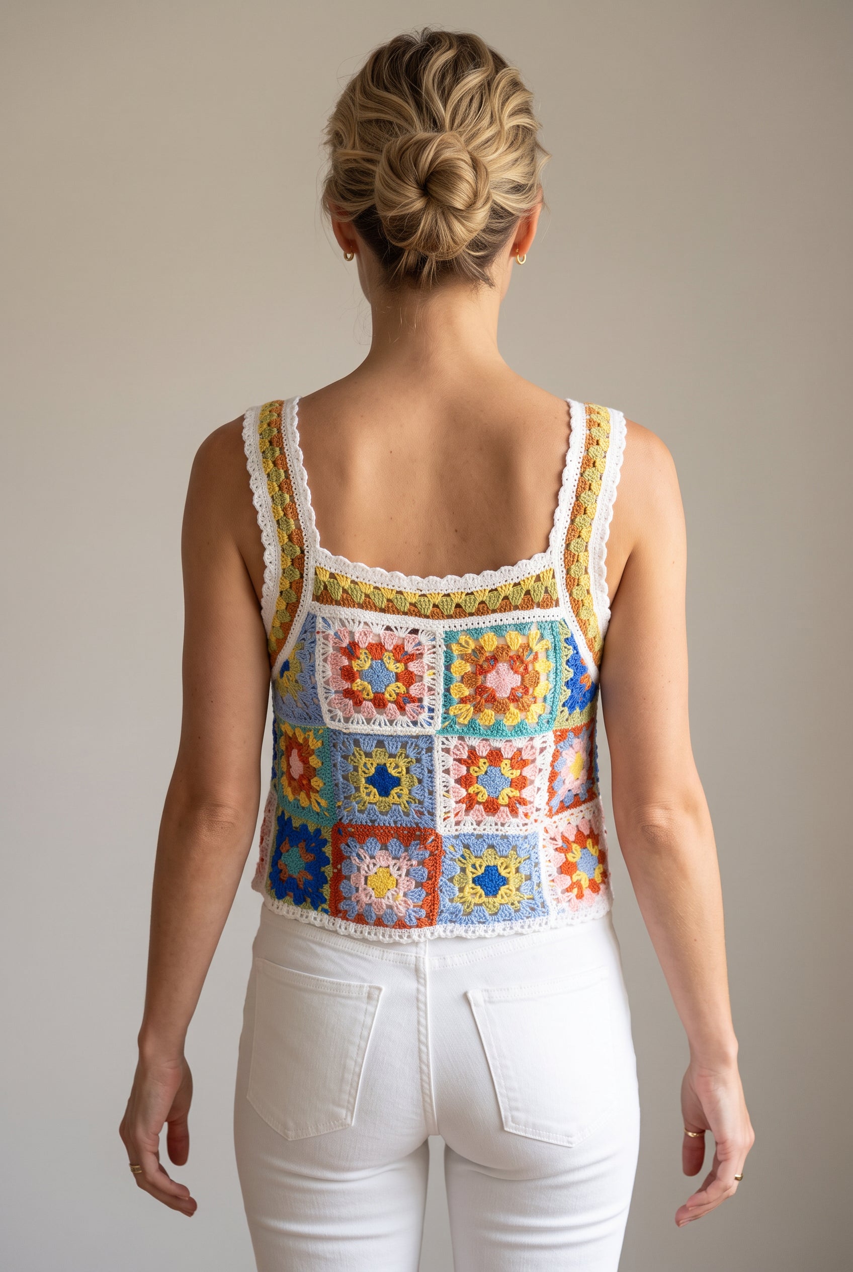 Back view of the crochet tank showing its clear square neckline, straps and patchwork panel.