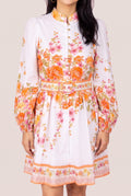 Sweet Sunshine floral mini dress in Small showing the mock neck, puff sleeves and belted front fit.