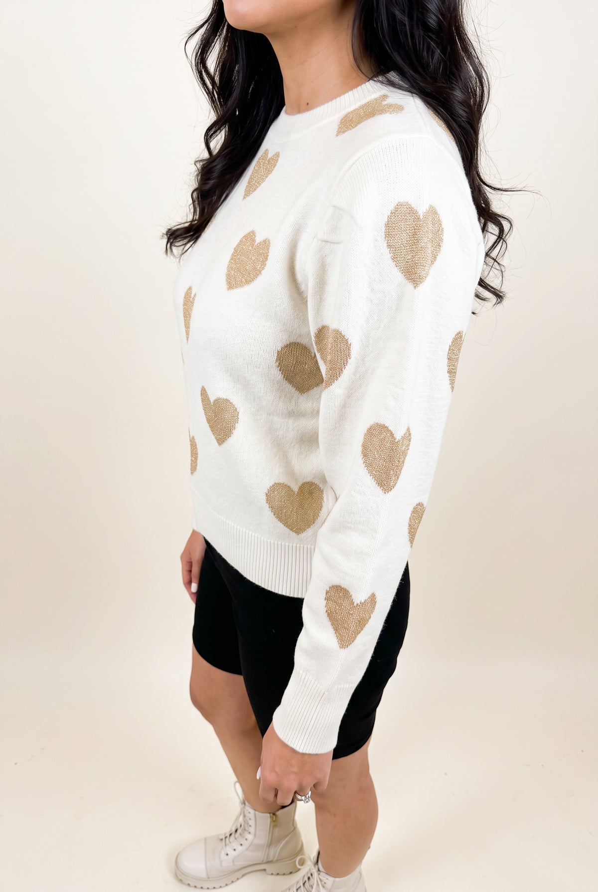 Angled side fit of the Make Me Feel Golden Heart Sweater showing body depth, sleeve volume and hem level.