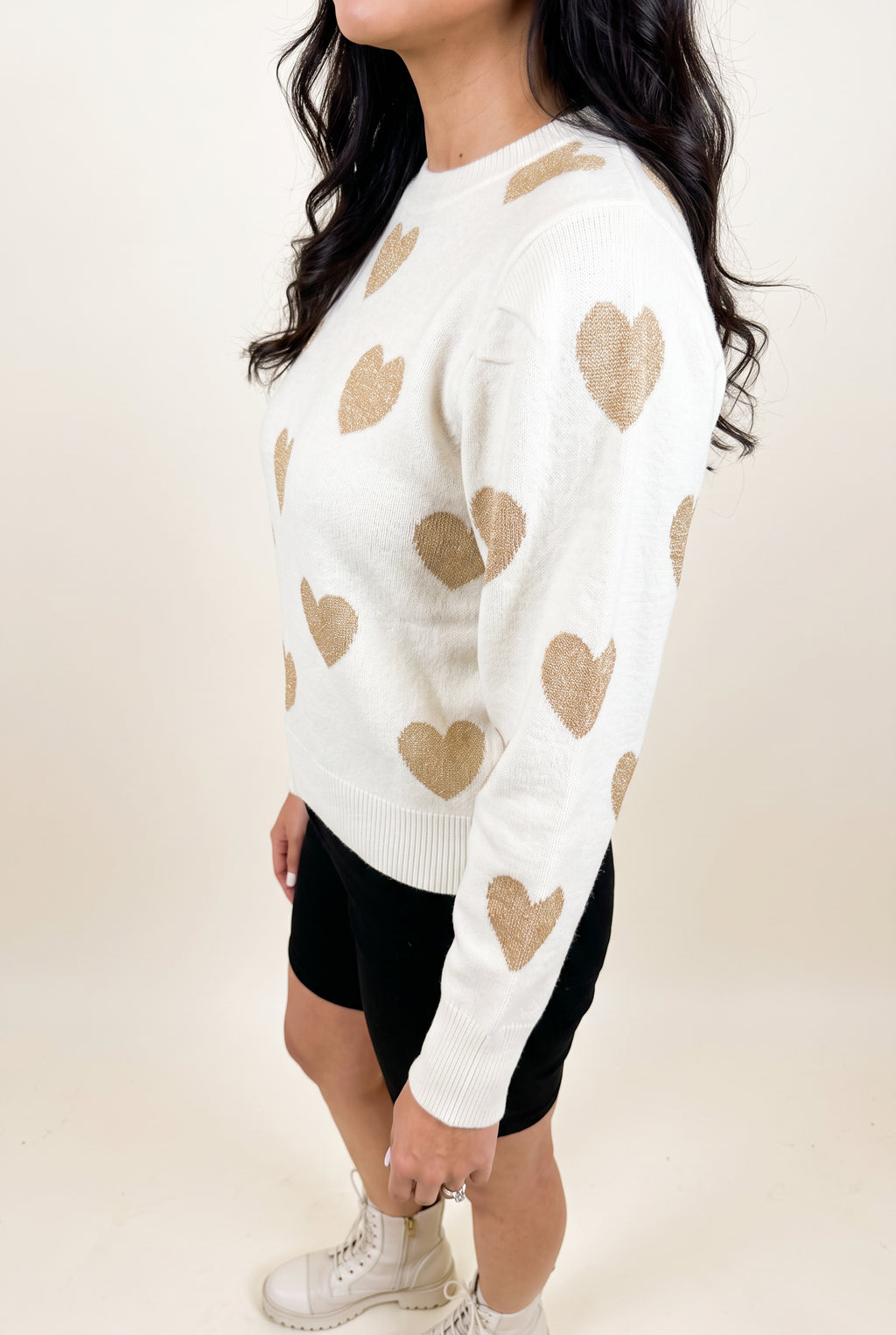 Angled side fit of the Make Me Feel Golden Heart Sweater showing body depth, sleeve volume and hem level.