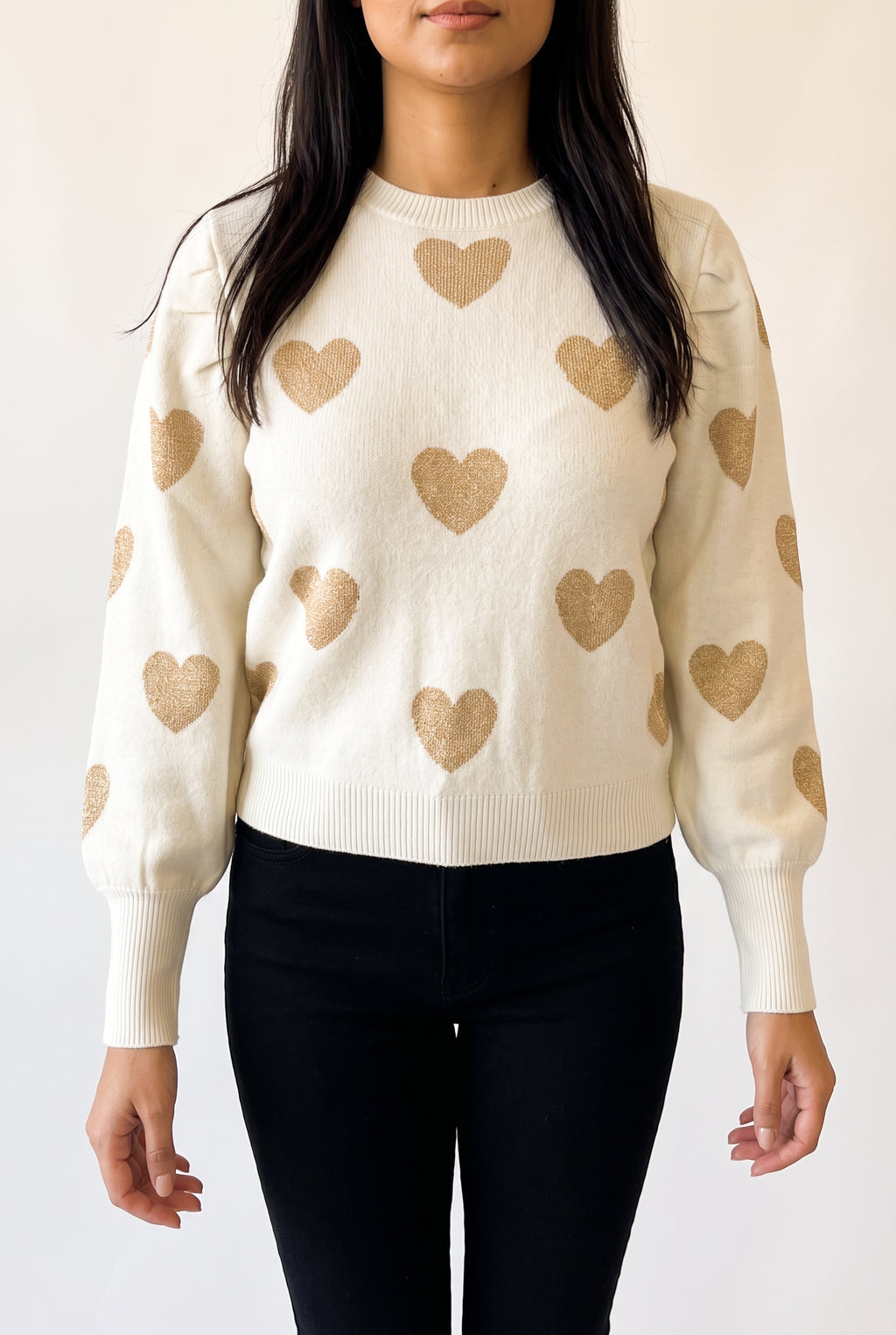Sleeve detail of the Make Me Feel Golden Heart Sweater showing its tapered shape, deep cuff and gentle knit give.