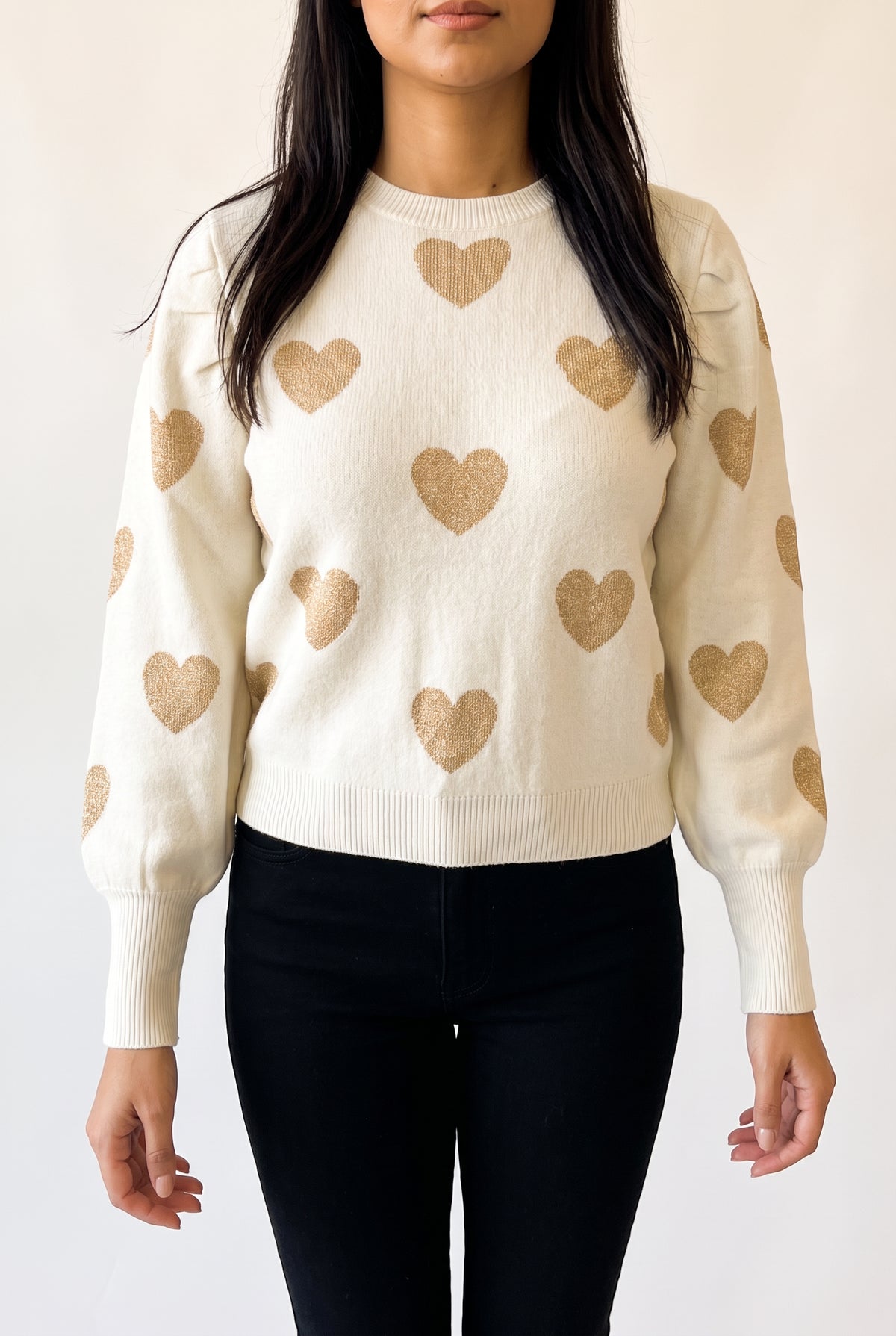 Sleeve detail of the Make Me Feel Golden Heart Sweater showing its tapered shape, deep cuff and gentle knit give.