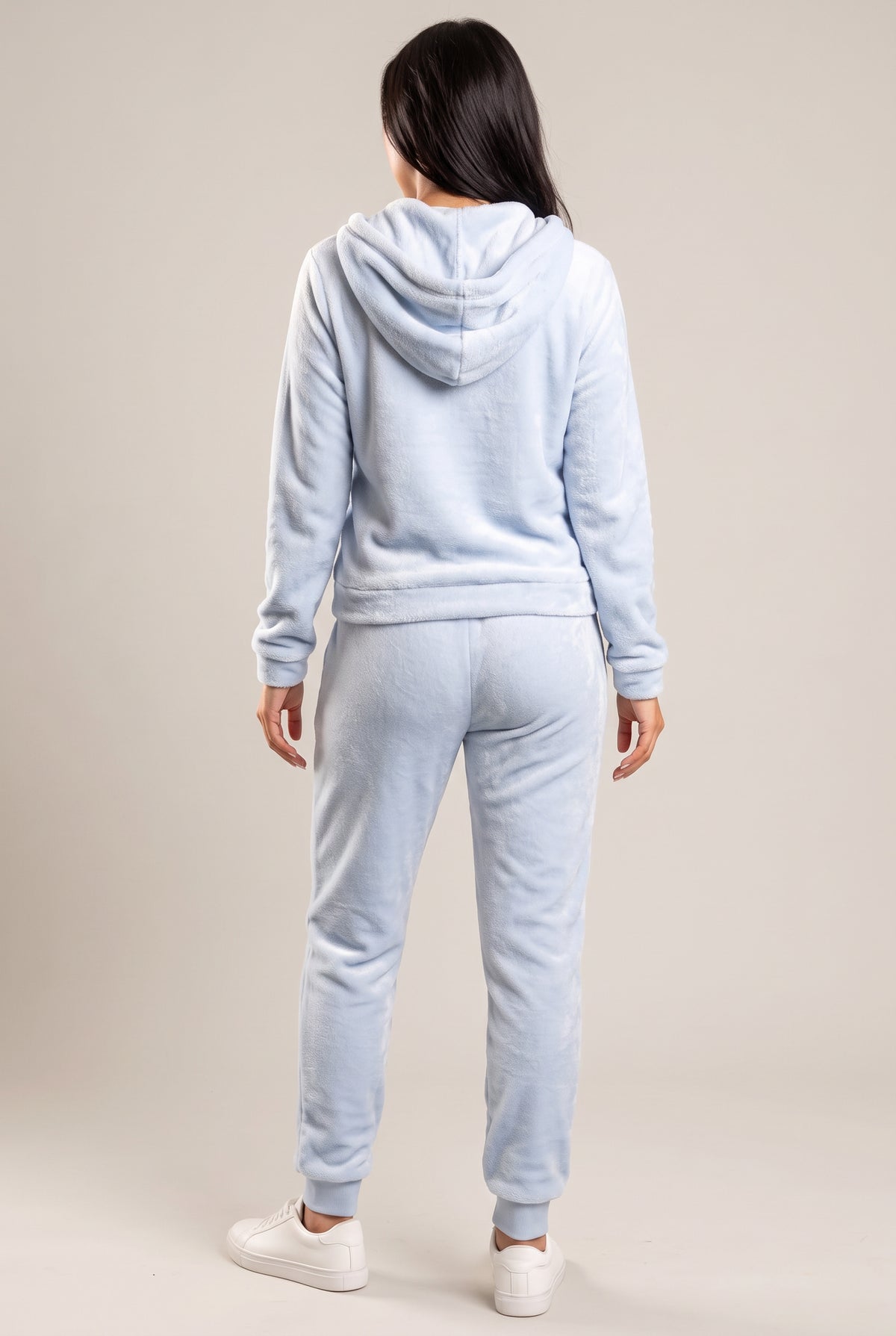 Rear three-quarter view of the light blue plush hoodie and jogger set with the hood down.