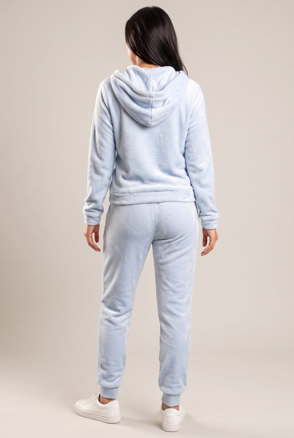 Rear three-quarter view of the light blue plush hoodie and jogger set with the hood down.