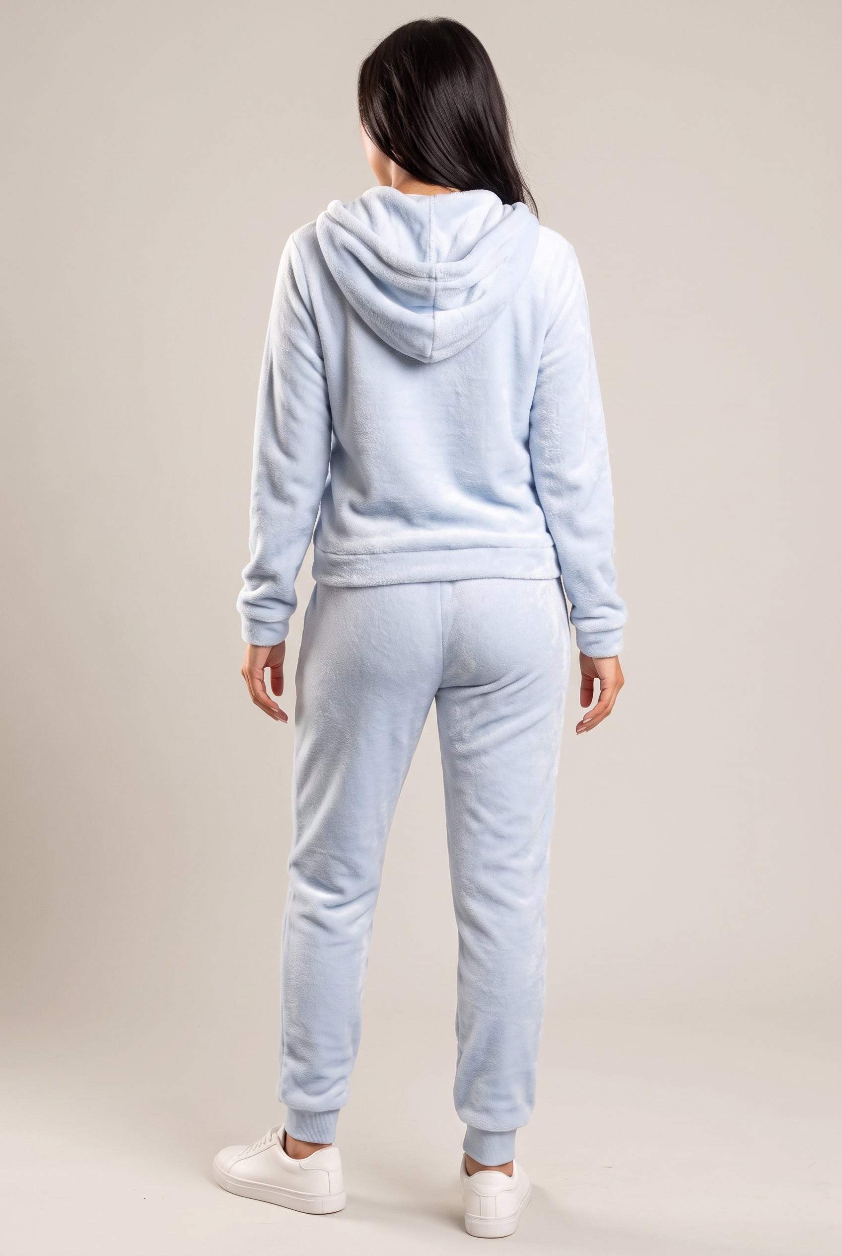 Rear three-quarter view of the light blue plush hoodie and jogger set with the hood down.