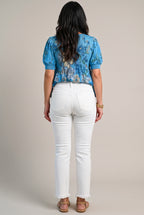 Back view of All of Me white cropped jeans showing the yoke, patch pockets, seat fit and raw hems.