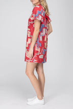 Angled side fit of the red printed mini dress showing sleeve volume and body depth.