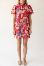 Front fit of the Bold Statement Bubble Sleeve Tie Back Dress in Small Red.