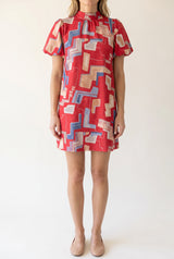 Front fit of the Bold Statement Bubble Sleeve Tie Back Dress in Small Red.