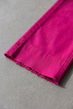Bright Side High Rise Straight Pants close-up showing the Fuchsia fabric and raw-cut hem.