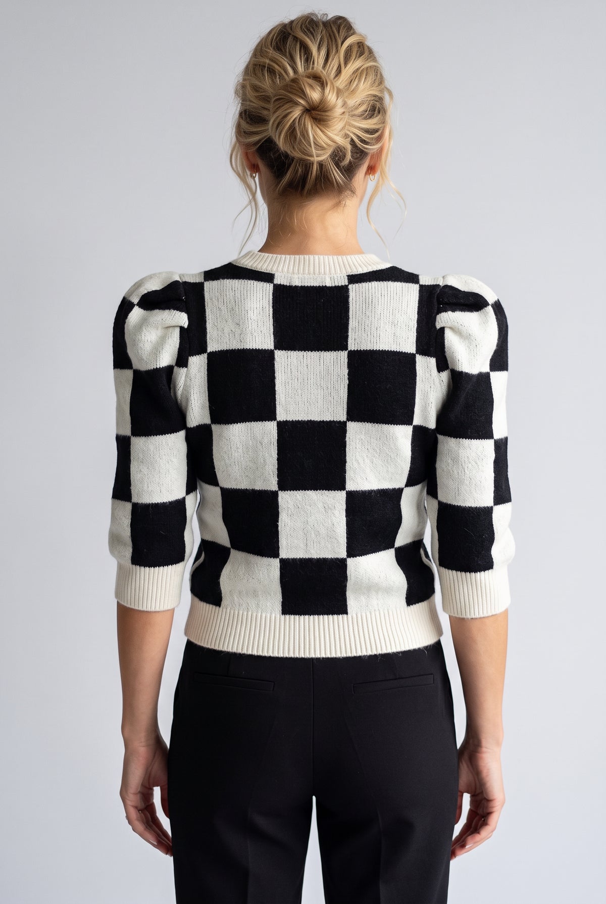 Best-guess back view of the Checkmate Chic sweater showing rear length and ribbed hem.