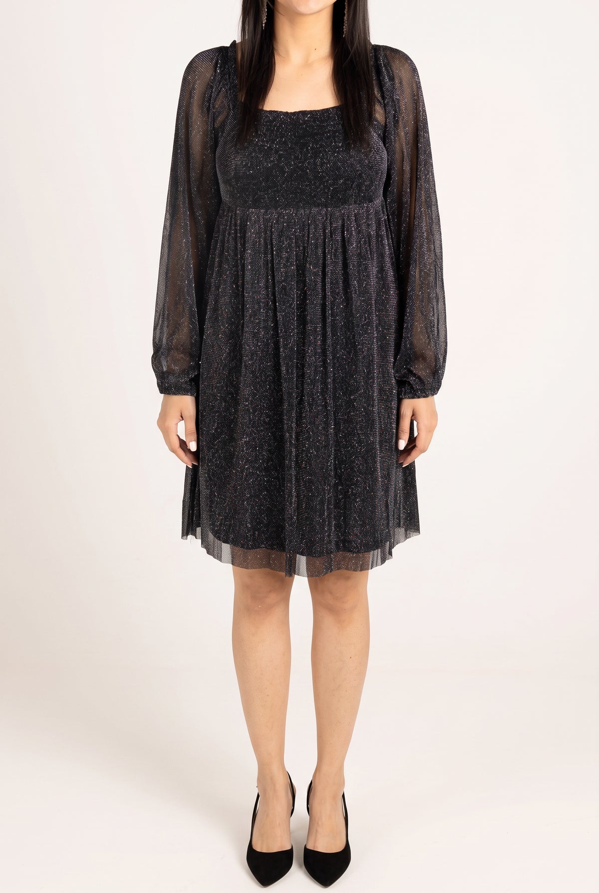 Front fit of the black glitter babydoll dress showing its square neck and above-knee hem.