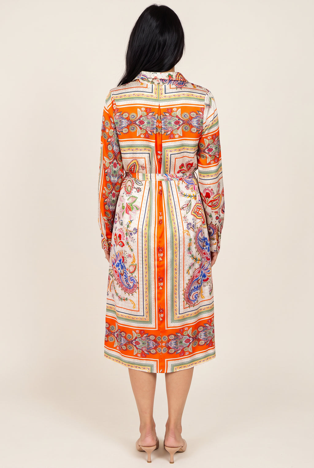 Back view of the scarf-print shirt dress showing the centered orange stripe, tie belt, and midi hem.