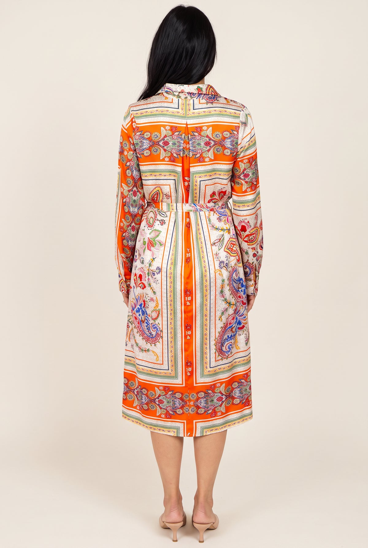 Back view of the scarf-print shirt dress showing the centered orange stripe, tie belt, and midi hem.