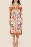 Front view of the scarf-print shirt dress in Small showing its tie waist and midi length.