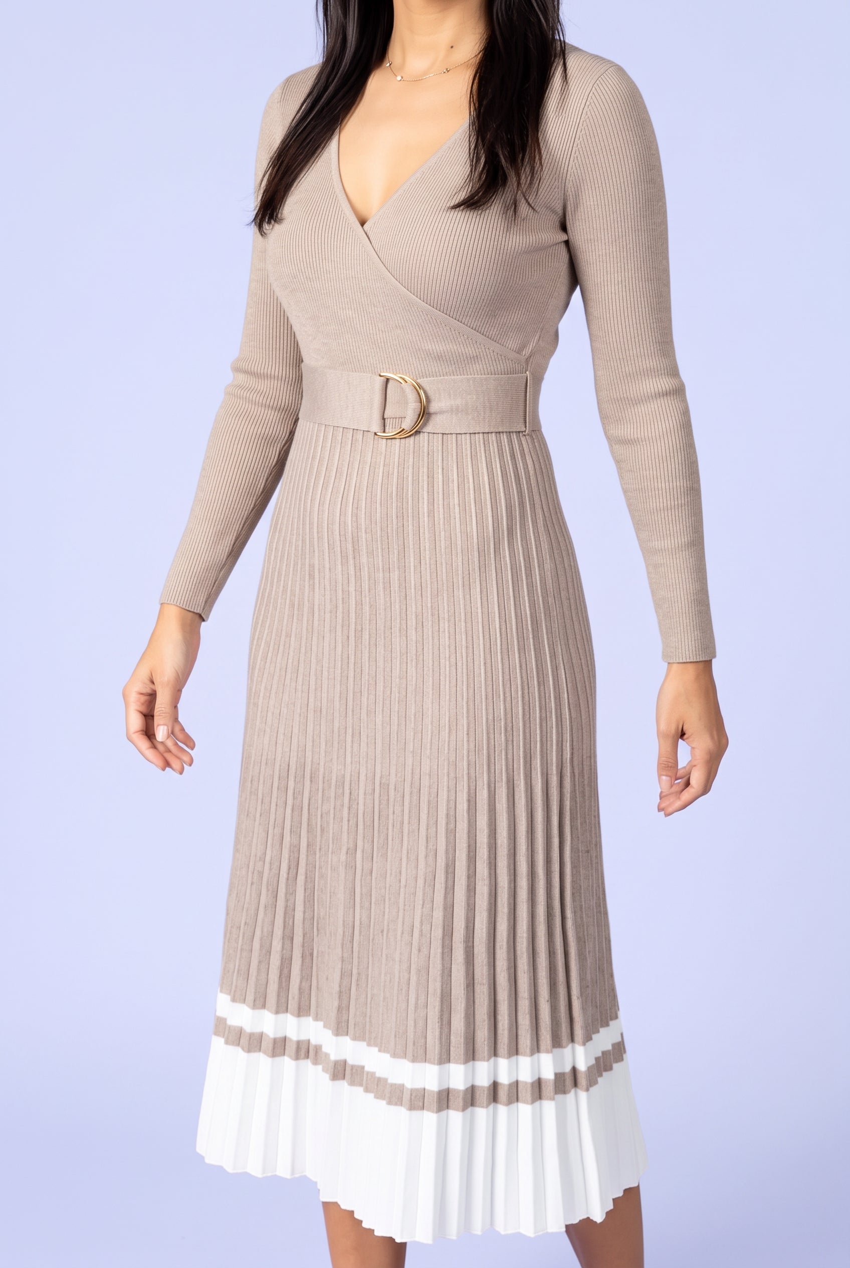 Close view of the sweater dress rib knit, wrap bodice, D-ring belt and pleated skirt.