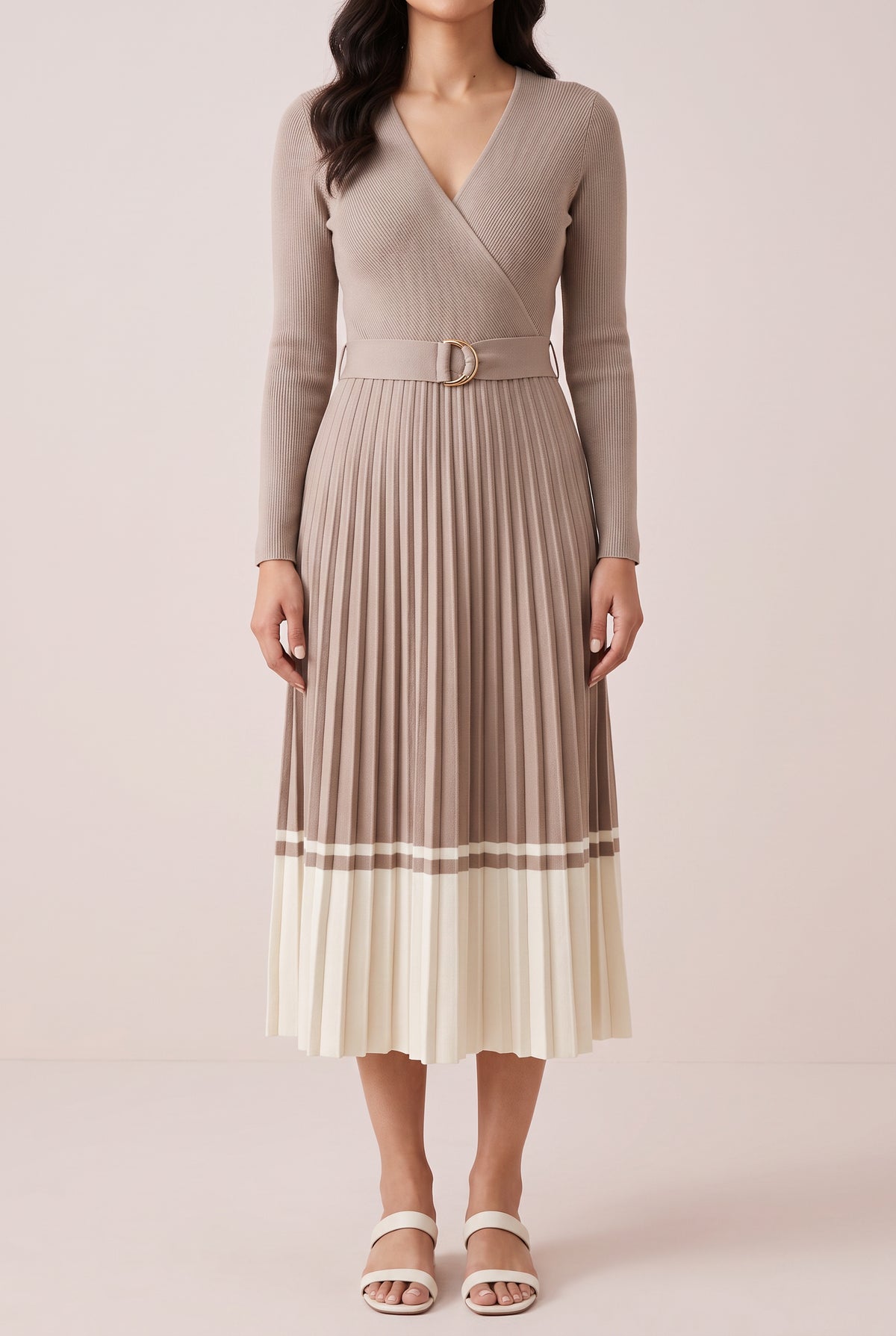 Angled side fit of the beige pleated sweater dress in Small, showing its waist and midi length.