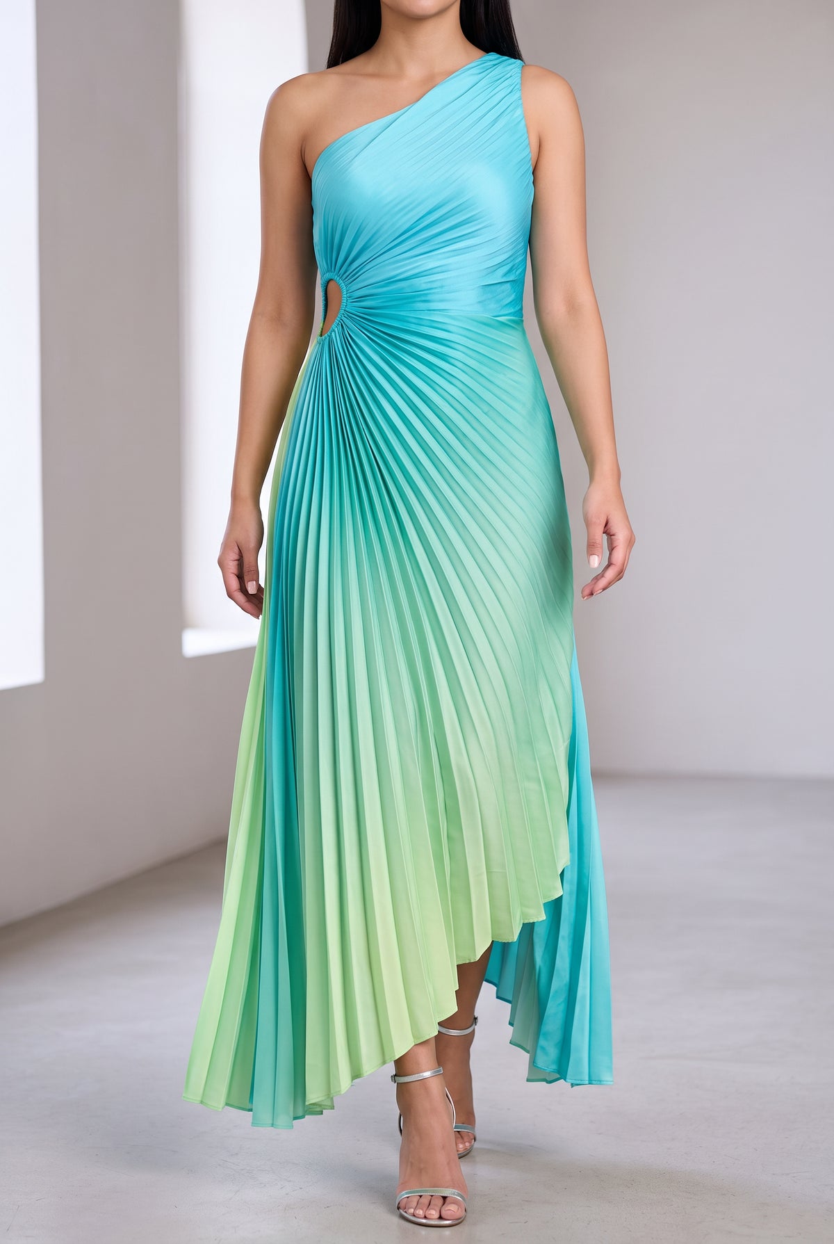 Ombre pleated dress worn with strappy heels in an elegant cocktail setting.