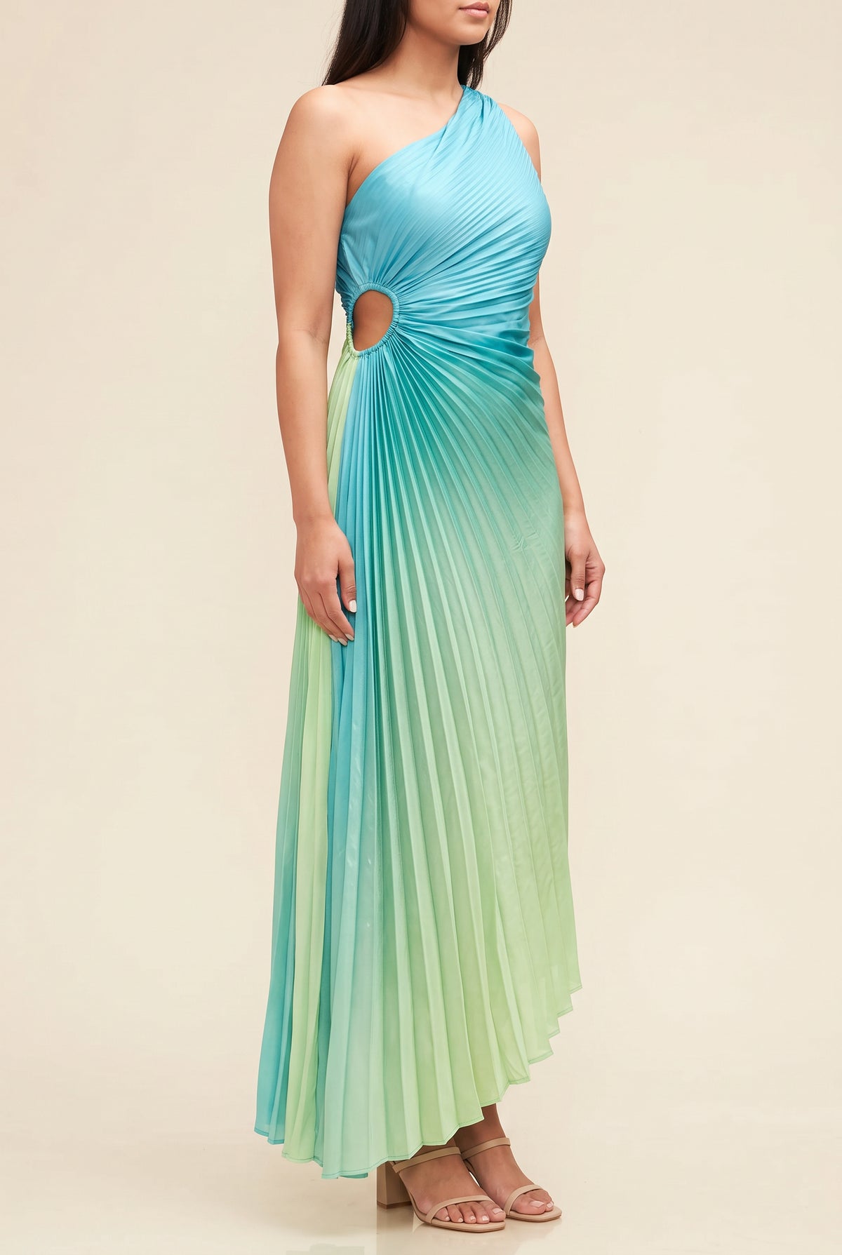 Angled side fit of the ombre pleated dress showing the waist cutout and dipped hem.